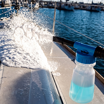 Boat covered in thick foam from hose foam cannon showing cleaning coverage and soap application